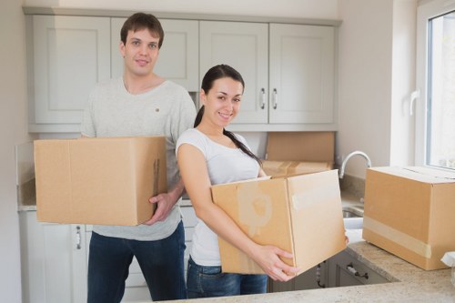 Professional movers handling packed boxes for a Brentcross house move